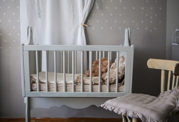 Cosy baby room with baby cot and soft toys