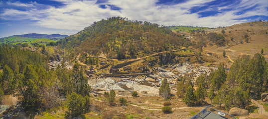 Adelong falls and gold mill ruins on bright sunny day, NSW, Australia - aerial panorama © Greg Brave