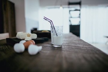 Sliced cheese circle, eggs and milk on a table