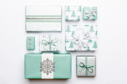 Beautiful Nordic Christmas Gifts Isolated On White Background. Turquoise Colored Wrapped Xmas Boxes. Gift Wrapping Concept.