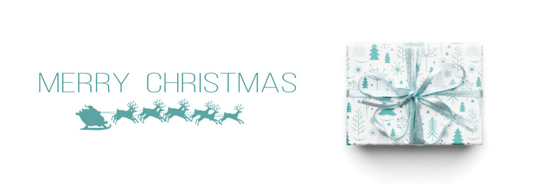 Christmas banner. Beautiful christmas gift isolated on white background. Turquoise colored wrapped xmas box. Gift wrapping concept.