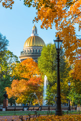 St. Isaac's Cathedral in autumn, yellow orange leaves, street lights, Saint-Petersburg.
