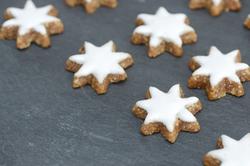 cinnamon  stars lying on black slate