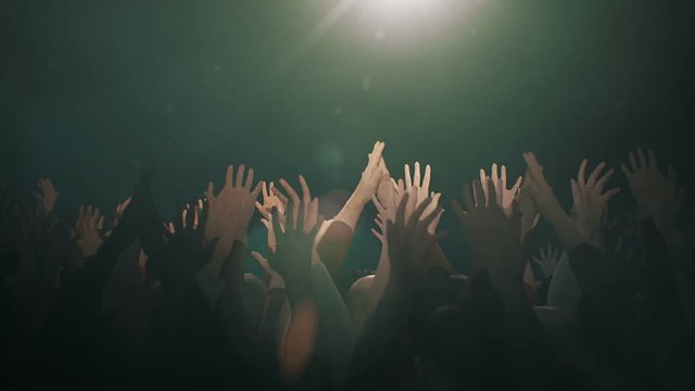 Hands raised in worship with lens flare and white Dove.