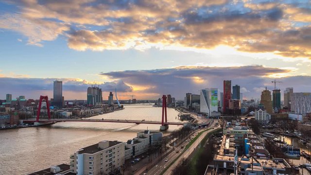 Beautiful 4K UHD cityscape urban timelapse of the skyline of Rotterdam, the Netherlands, with the river Meuse (Maas) and the Erasmus bridge at sunset from day to night