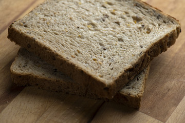 Two pieces of toast on wooden table