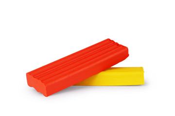 Pile of colored plasticine bricks on a white background