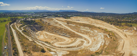 Closed limestone mine and mountains in Melbourne, Australia - wide aerial panorama