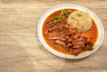 Stewed pork leg on rice (Kao Kha Moo) with boiled egg garlic and kale in bowl on table. food Popular menu Thailand.