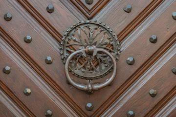 The old and ancient door with door knocker.