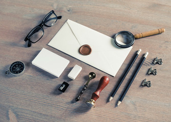 Vintage envelope and stationery on wooden background. Mock-up for your design.