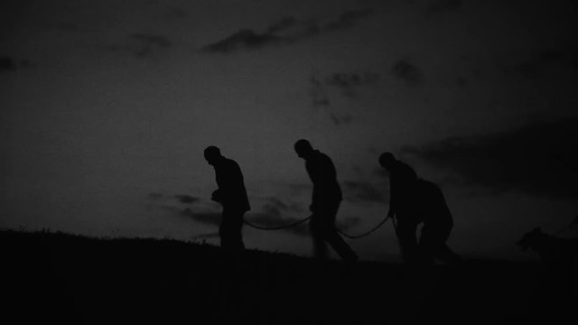 Prisoners and communist militia at midnight. The clip can illustrate Persecution of Christians in the Eastern Bloc.