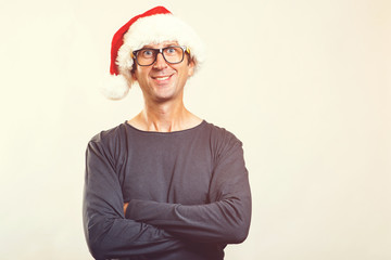 Smiling man in glasses wearing Santa hat. Happy new year. Christmas time. Funny man in Christmas hat, isolated on white. Copy space. Christmas mood. People, christmas, sales and lifestyle concept.