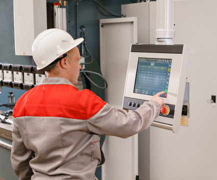 control computer display of Machine. Manufacture workers adjusts the machine in the warehouse. the production of ventilation and gutters. Tool and bending equipment for sheet metal.
