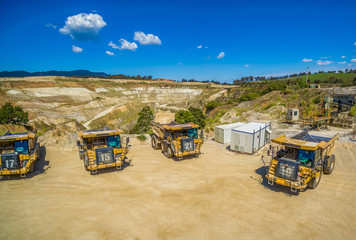 Heavy industrial machinery - huge yellow dump trucks © Greg Brave