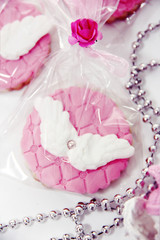 festive biscuits with pink cream and white wings decoration