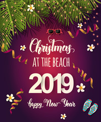 Christmas background with palm leaves, light bulbs, sunglasses, tropical flowers, serpentine and hand written quote "Christmas at the beach. Happy New Year 2019". Banner,poster, flyer, brochure