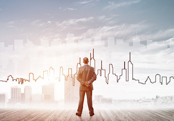 Motivation and inspiration concept with modern cityscape and businessman observing it