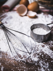 Pastry Baking Accessories Bakery Background with flour and whisk. Ingredients for the preparation of bakery products.