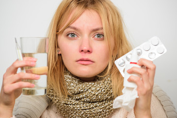 Girl hold glass water tablets and thermometer nasal drops. Getting fast relief. Ways to feel better fast. Headache and flu remedies. Get rid of flu. Woman wear warm scarf because illness or flu