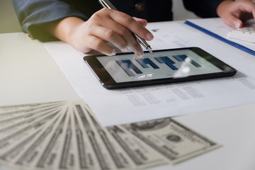 Women working in office. financial analysis with charts on pad for business, accounting, insurance or finance concept.