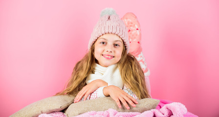 Obraz na płótnie Canvas Winter accessory concept. Girl long hair dream pink background. Winter season concept. Kid dreamy wear knitted hat. Winter rest and relax. Winter fashion accessory. Kid girl knitted hat and scarf