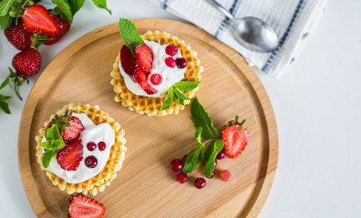 Waffles with whipped cream and strawberries