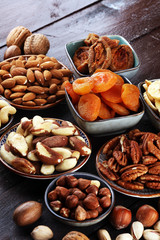 dried fruits and assorted nuts composition on rustic table