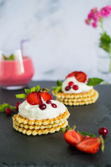 Obraz na płótnie Canvas Waffles with whipped cream and strawberries