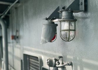 Deck lamp on ship in protective cage