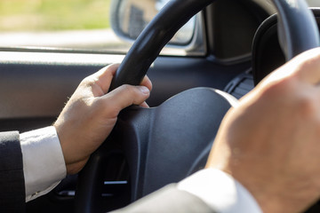 Man Hands Holding Steering Wheel, Driving Car Close-Up