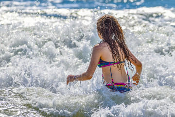 girl on the beach having a splash