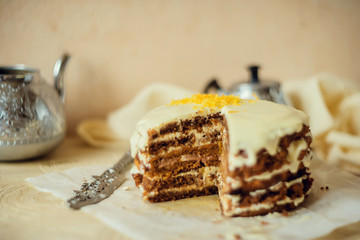 Homemade carrot cake on light background. The concept of autumn tea.