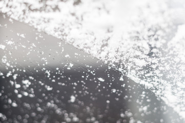 Snow on a car's front windshield selective focus