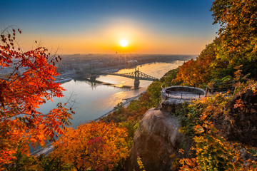 Budapest, Hungary - Panoramic skyline view of Budapest at sunrise with beautiful autumn foliage, Elisabeth Bridge (Erzsebet Hid) and lookout on Gellert Hill