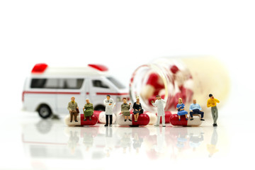 Miniature people : Doctor with patient in medical office with worker take Piill capsules,Health care concept.