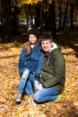 Father and little daughter in autumn park