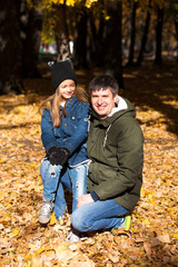 Father and little daughter in autumn park