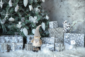 Beautiful silver and gold boxes with gifts under the Christmas tree. New Year and Christmas holidays
