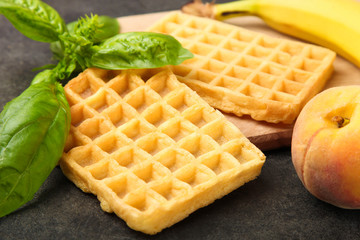 Belgian waffle with fruit on  black background. Concept dessert.
