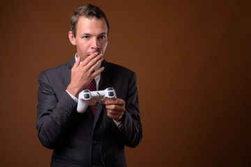 Studio shot of businessman against brown background