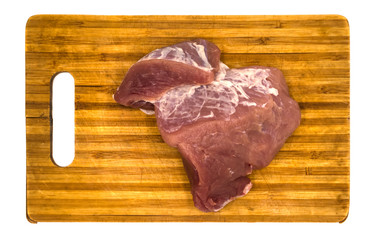 A piece of raw meat on a board isolated on white background