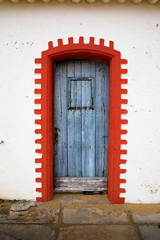 blue wooden door and red frame