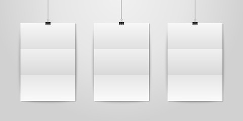 Three Vector Realistic White Blank Vertical A4 Folded Paper Poster Hanging on a Rope with Binder Clip Set on White Wall mock-up. Empty Poster Design Template for Graphics, Mockup