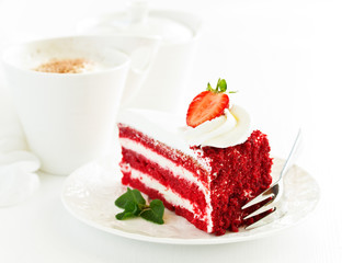 a piece of delicious red velvet cake on a plate.