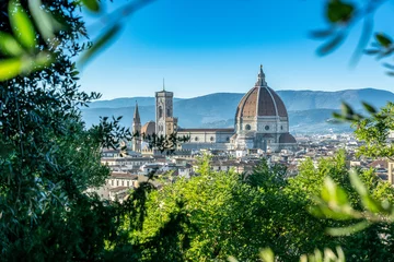 Foto op Canvas Panoramic view of the old town of Florence, Italy during the sunset with the view of famous Santa Maria del Fiore Cathedral through a bunch of trees. © Suradech