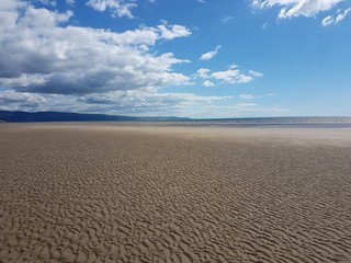 Beach landscape scene in Talybont, North Wales on a summer day.