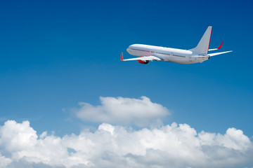 Fototapeta na wymiar White airplane flying above cloud