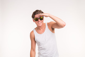 Handsome funny man in sunglasses over white background with copy space