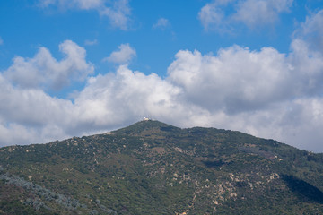 Fototapeta na wymiar Mountain with Clouds in the Sky